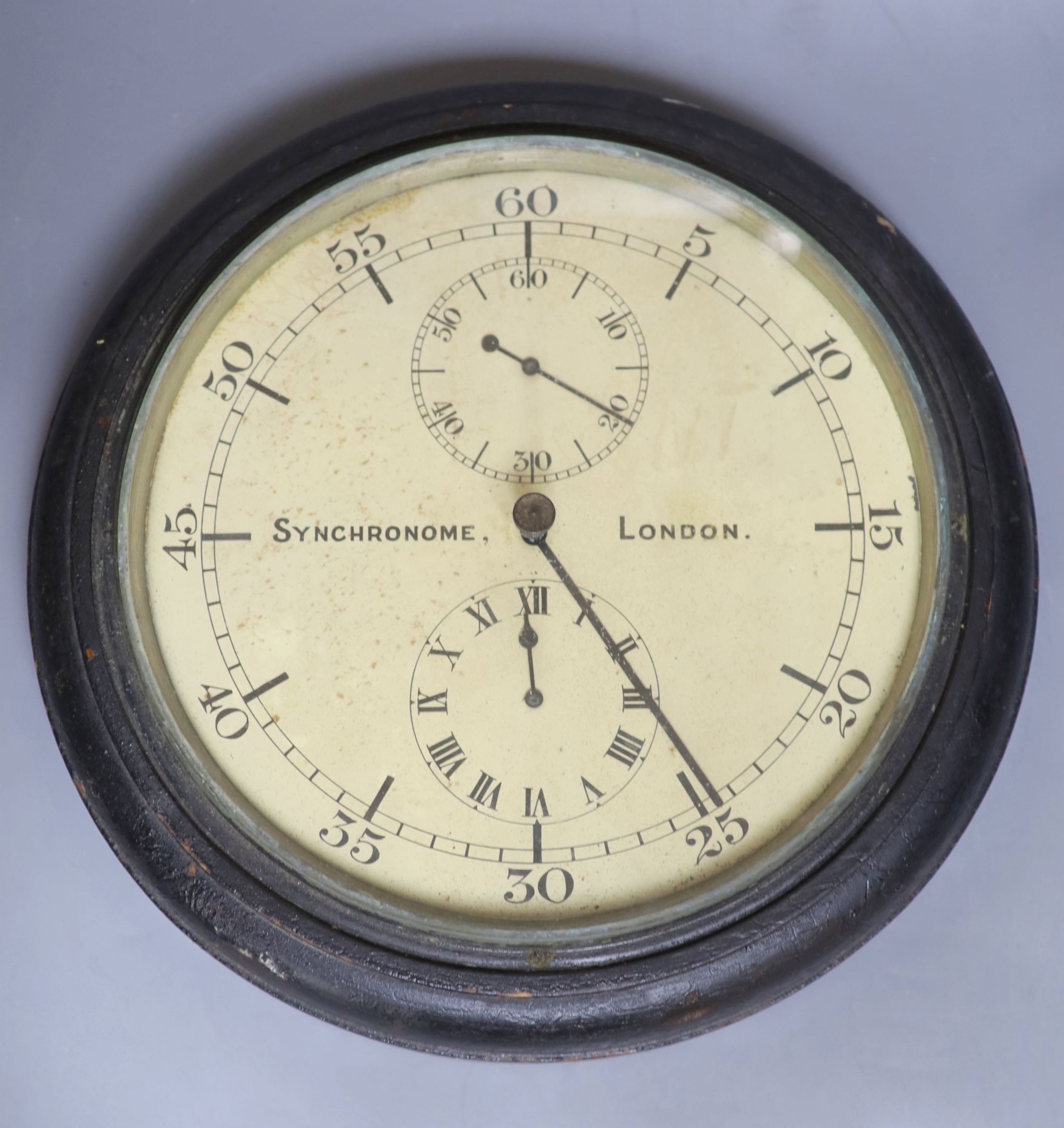 A Synchronome ebonised slave wall clock with two subsidiary dials,